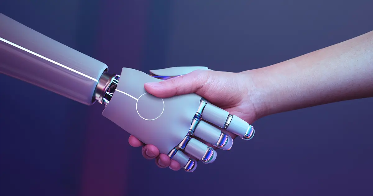 A human hand shaking hands with a robotic hand