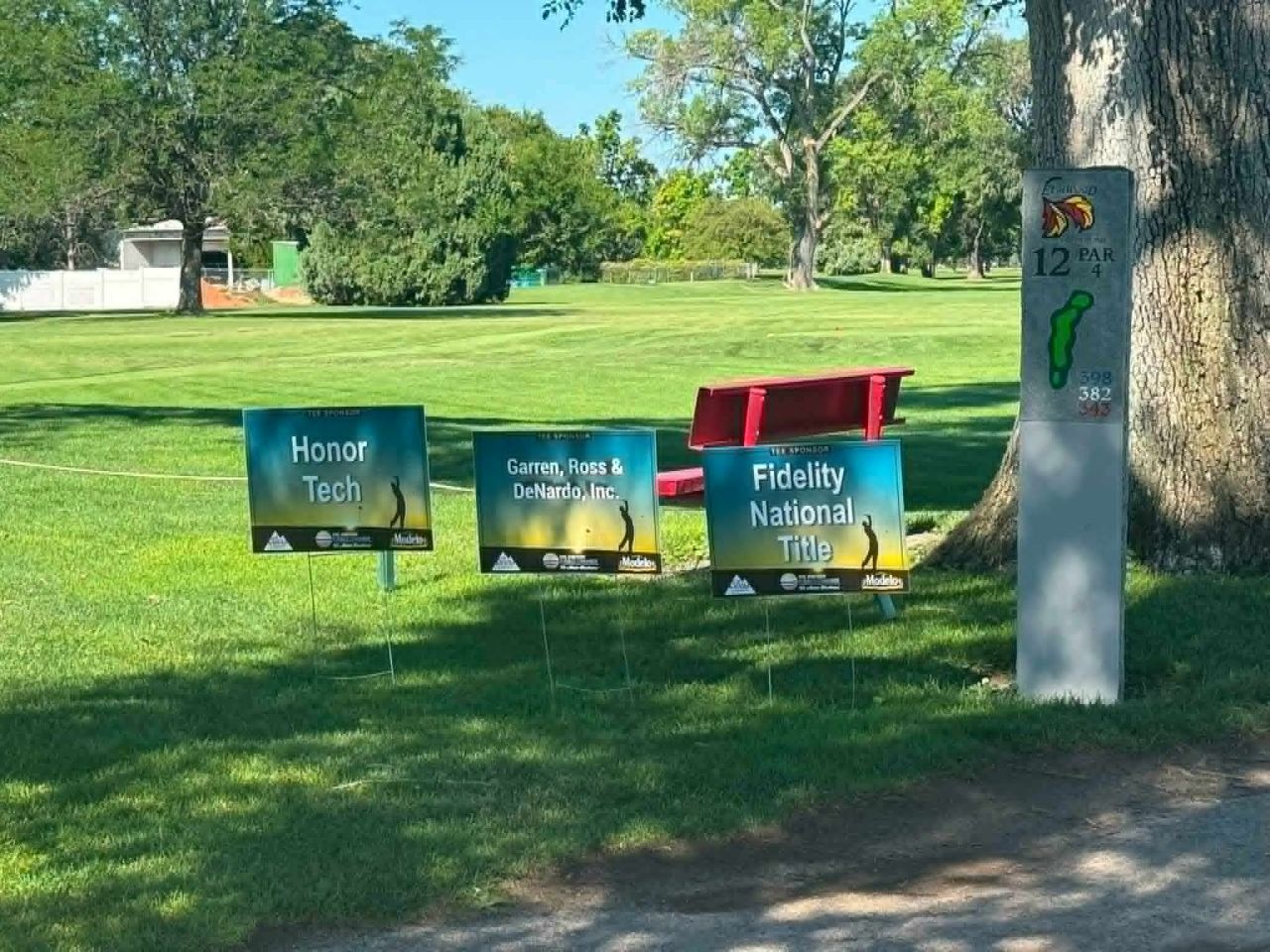 Honor Tech tee sponsor sign at the Greater Pueblo Chamber of Commerce golf tournament